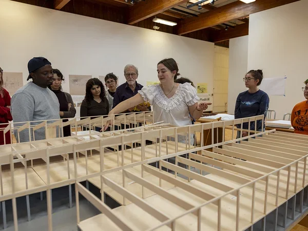 Students gather around an architectural model of VAPA