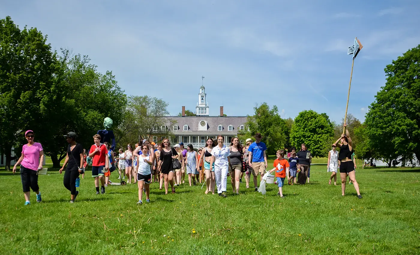 Puppet show audience marching to the end of Commons Lawn