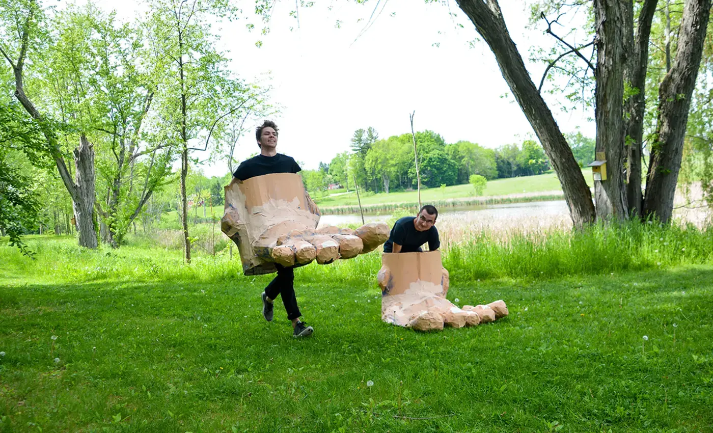 Giant feet walking across lawn as part of puppet performance