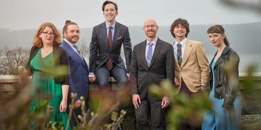 group picture of ekmeles group outside in formal attire