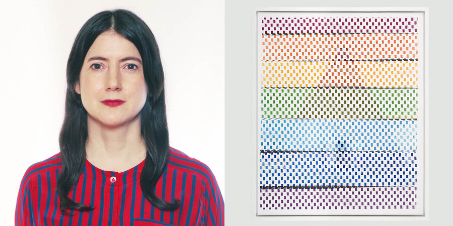 woman with red shirt and dark hair beside a piece of hanging art that looks like a chart