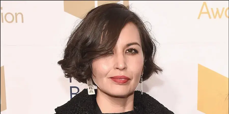 headshot of woman with short brown hair and lipstick