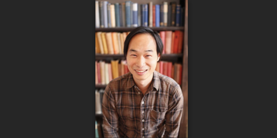 headshot of Tung-Hui Hu in front of a bookcase