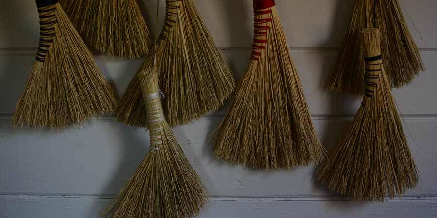 brooms hung on a wall