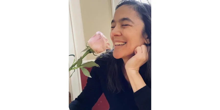 Joyelle McSweeney smelling a rose