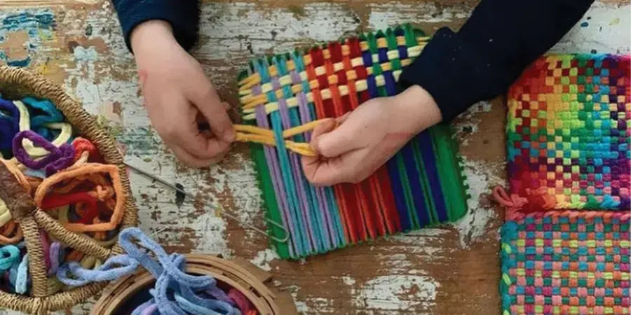 Person weaving classic cotton potholders.