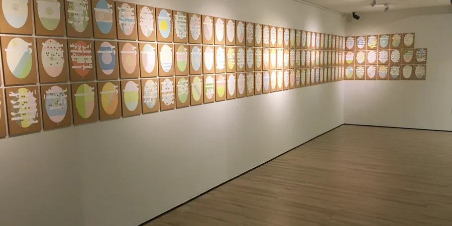 Art lining walls of a gallery