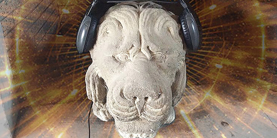 stone lion wearing headphones