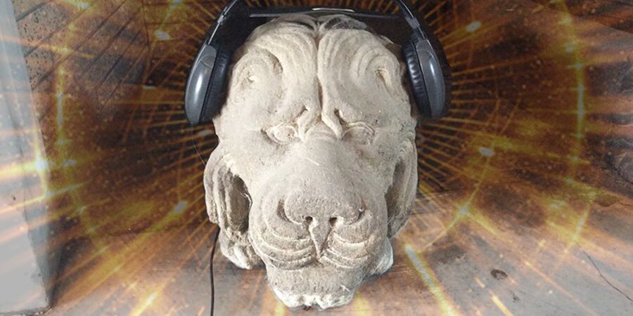 Stone lion with headphones on