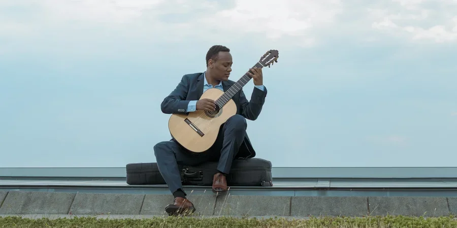 Raphaël Feuillâtre outside with a guitar