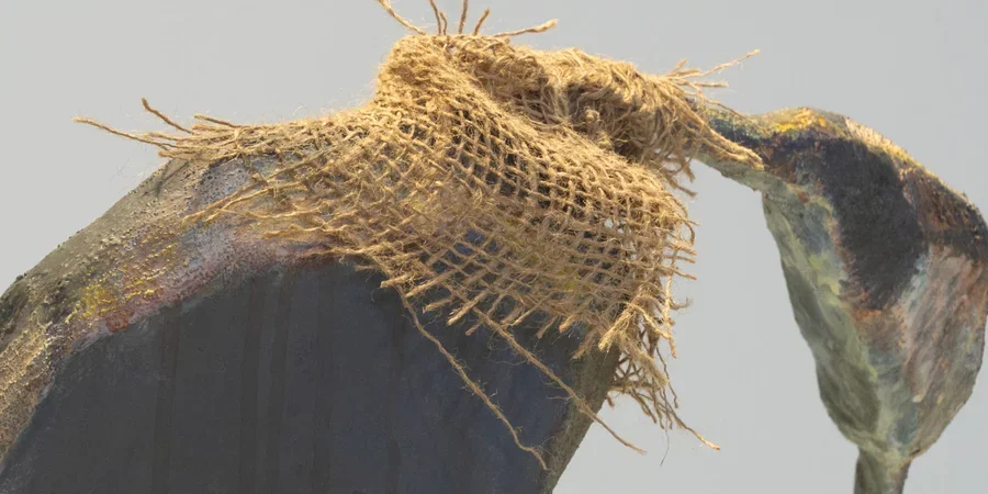 Piece of artwork with netting and grey background