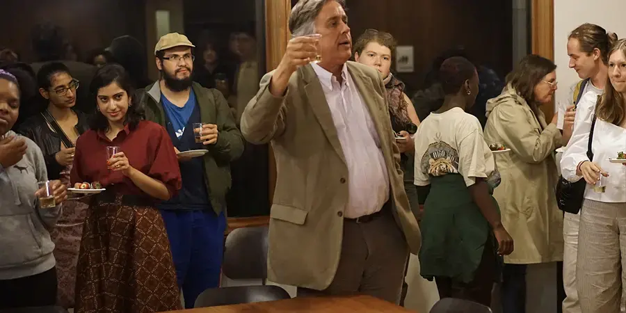 A group of students and faculty raise a toast 