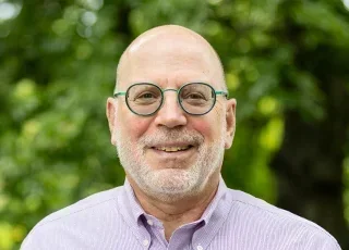 Fred Baumgarten headshot with tree in background