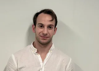 Tyler Ethier headshot in front of wall