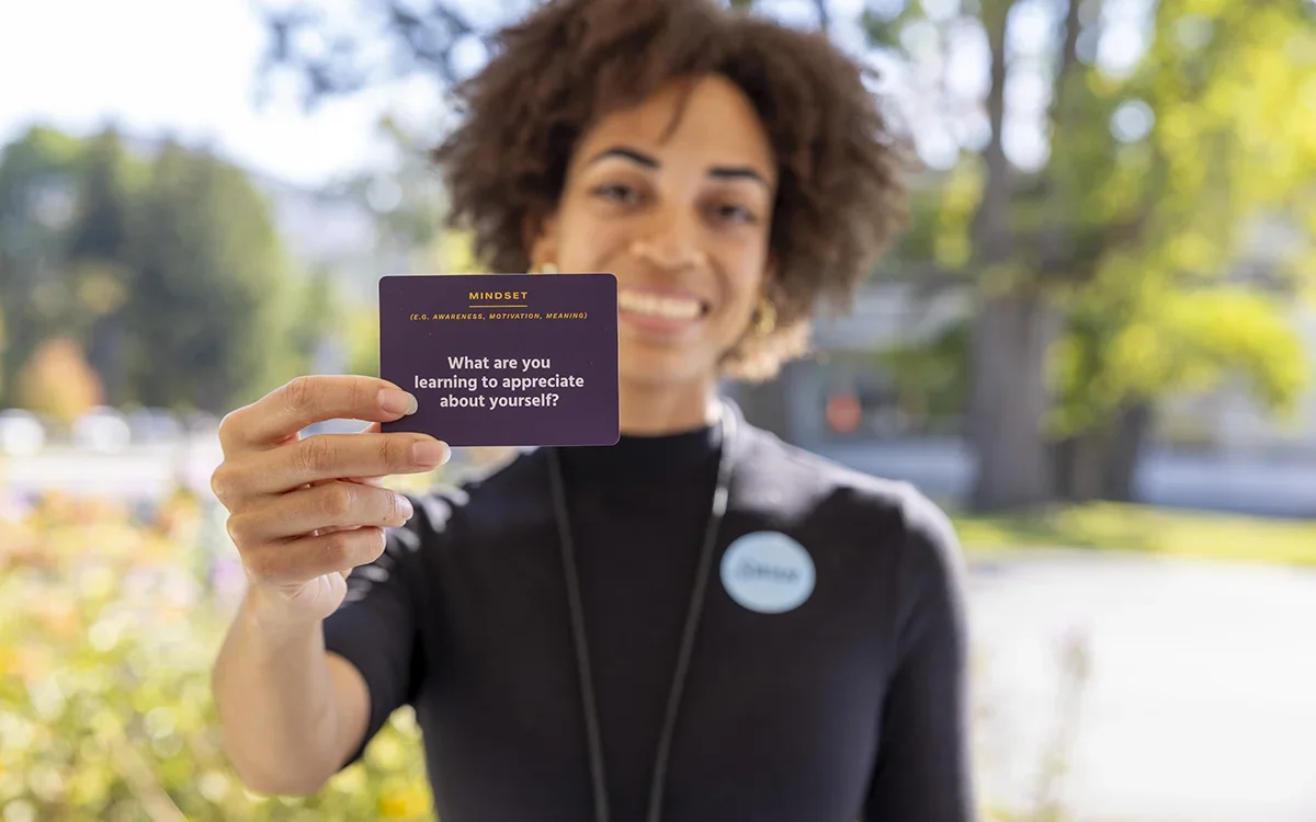 Dānia Clarke holding conversation card