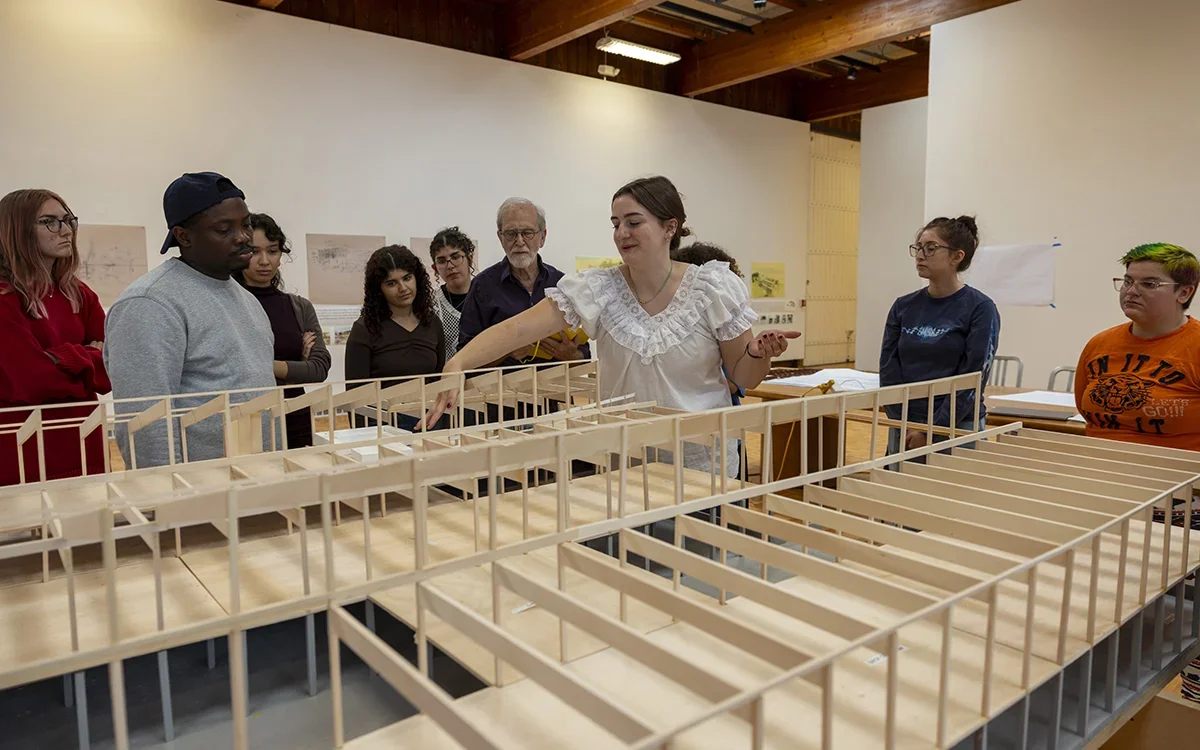 Students gather around an architectural model of VAPA