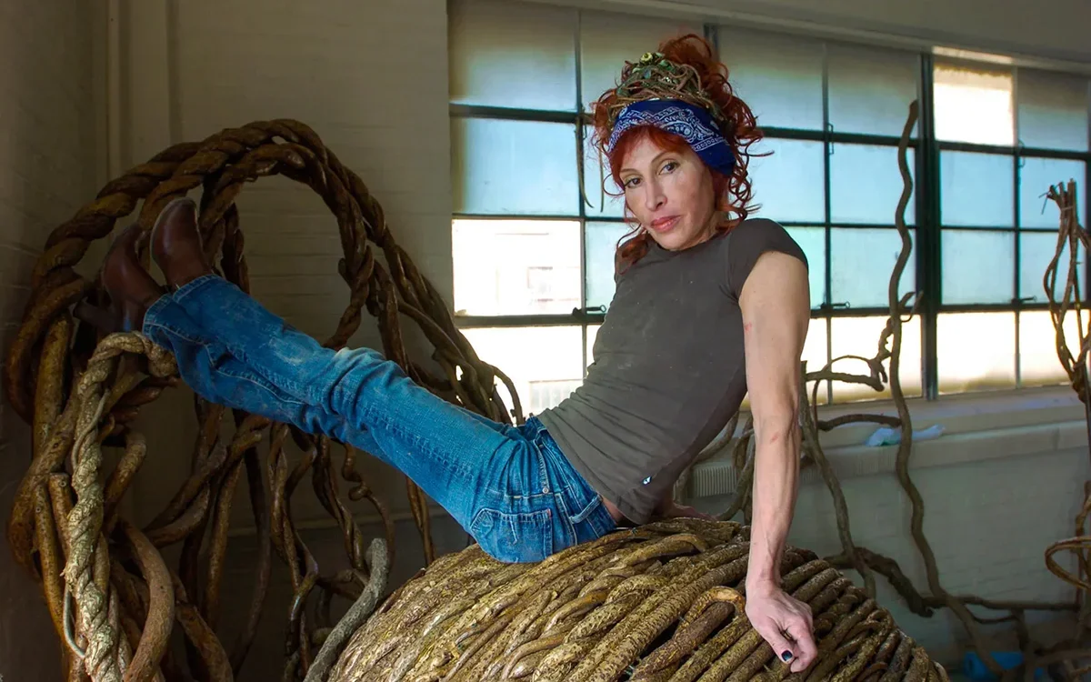 Laura Spector atop a Sculpture
