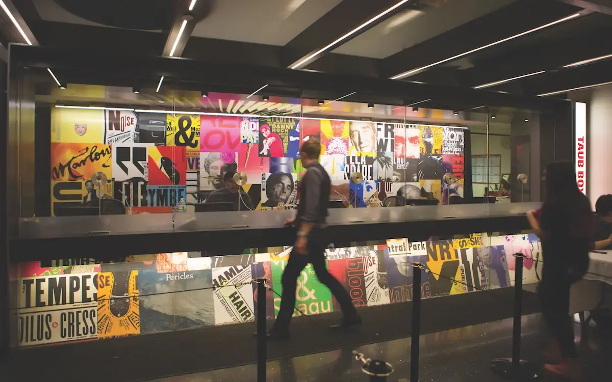 Man walking by multimedia art piece