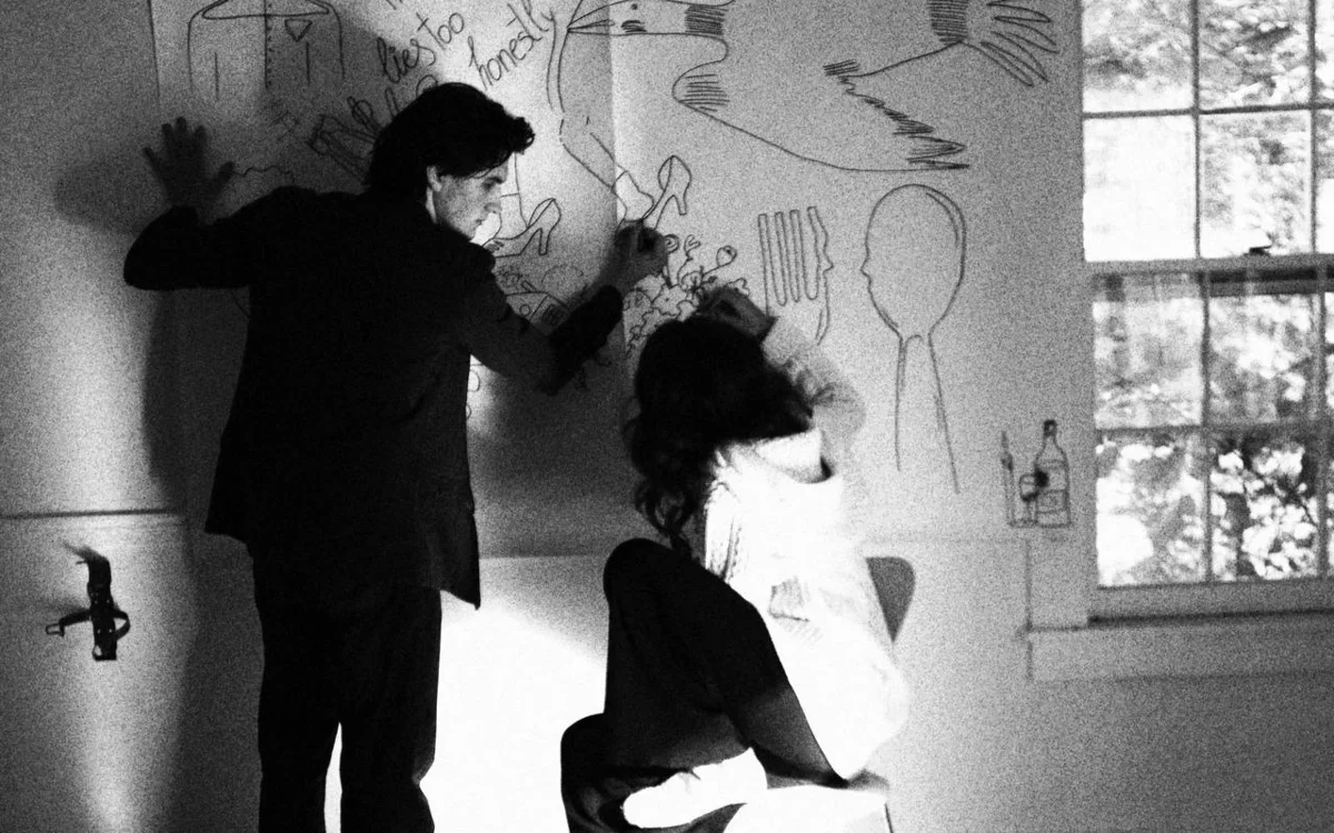 Polina Stolar '27 and Thelonious Shores '27 against wall of text