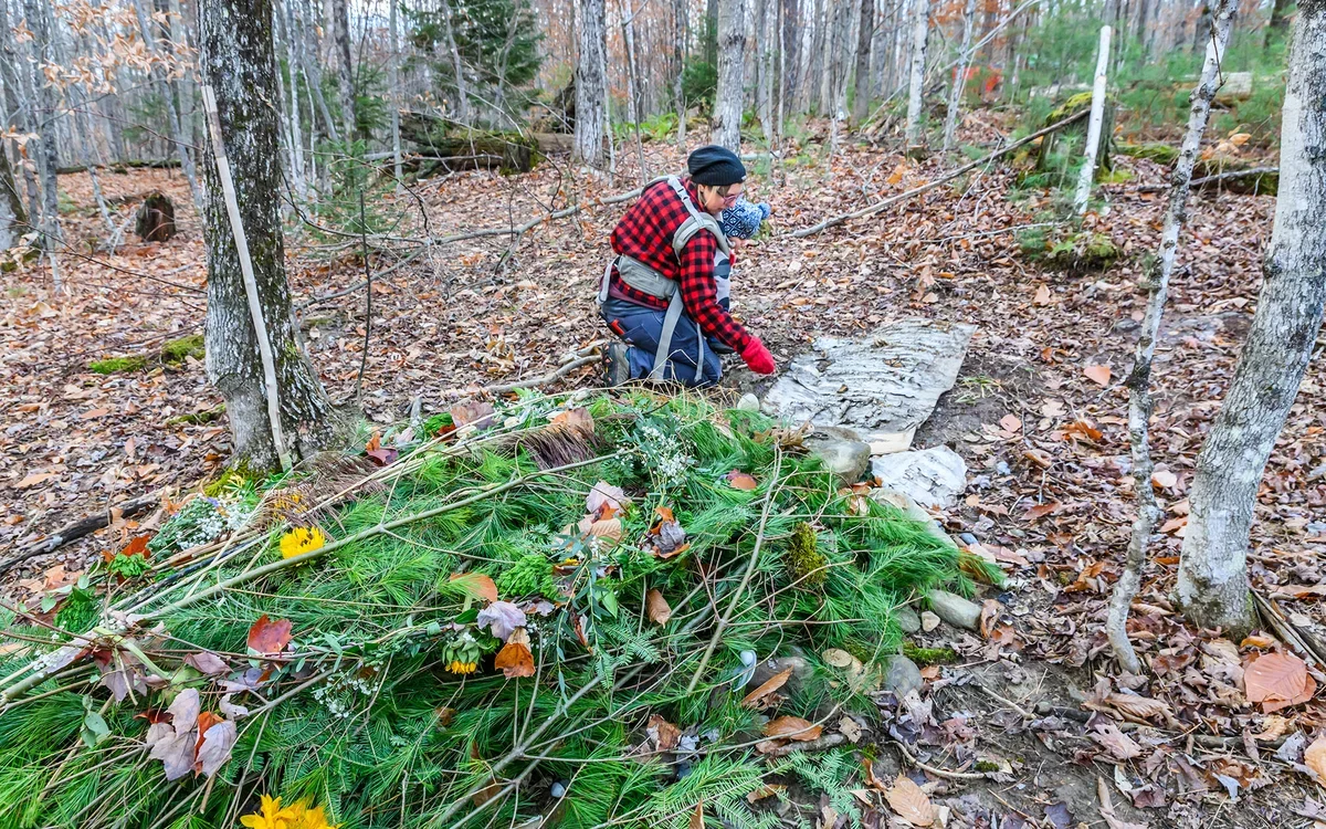 Michelle Hogle Acciavatti tends a recent grave at the Vermont Forest Cemetery. Photo by John Lazenby.
