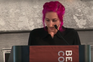 Student with pink hair speaks at Bennington College podium