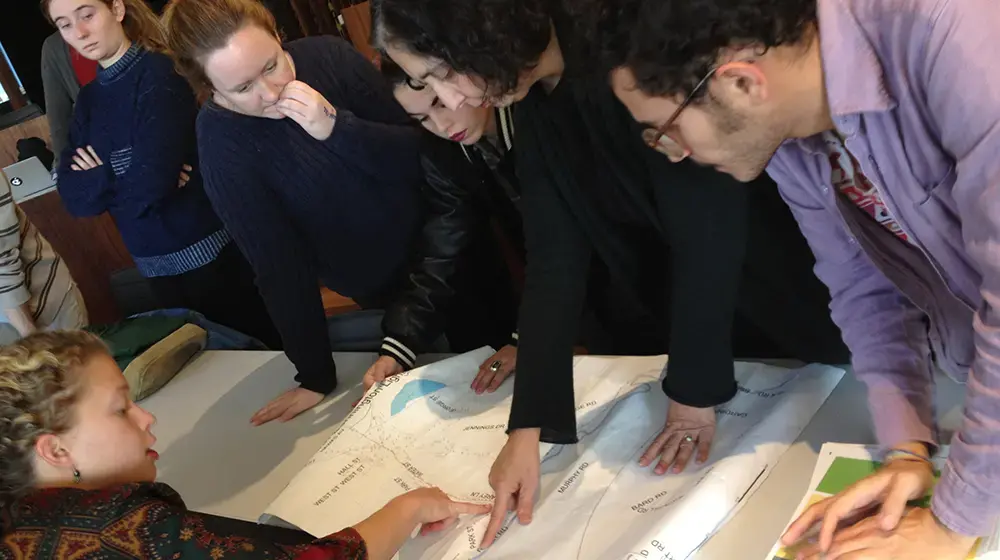 Students reading a map of streetlights in North Bennington, Vermont