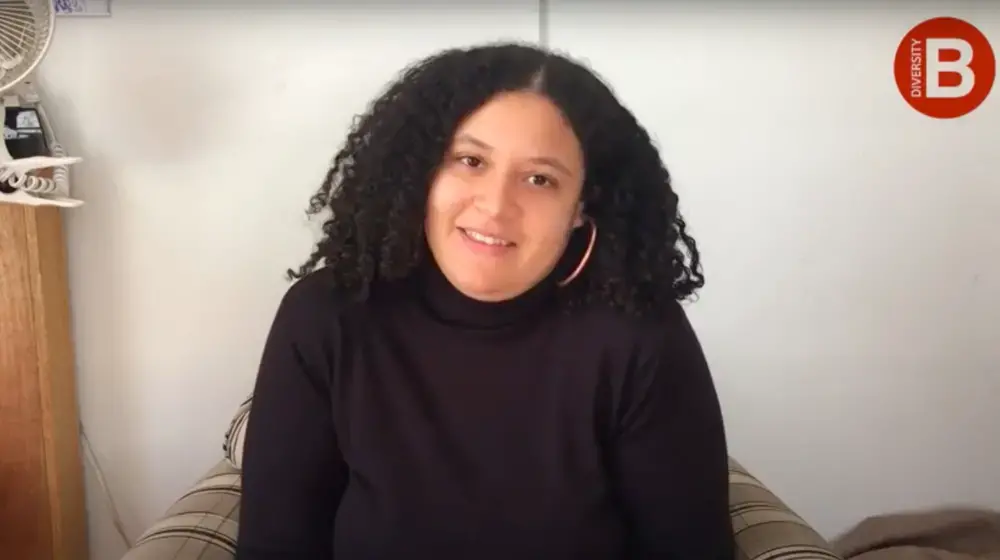 Photo of woman in front of bedroom wall