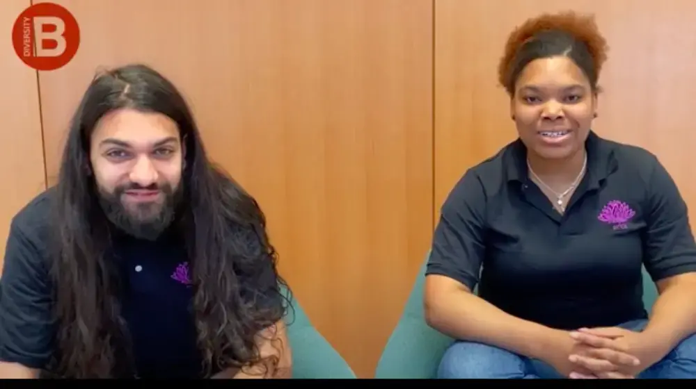 Photo of man and woman in front of brown background