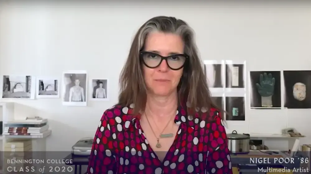 Image of woman in front of wall of photographs