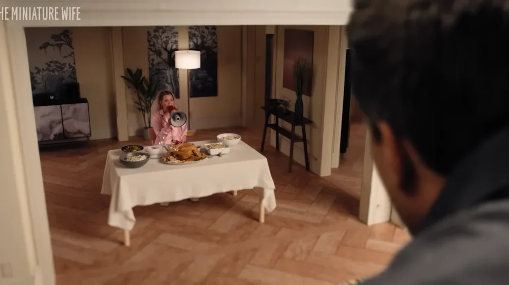 Image of small woman sitting at table