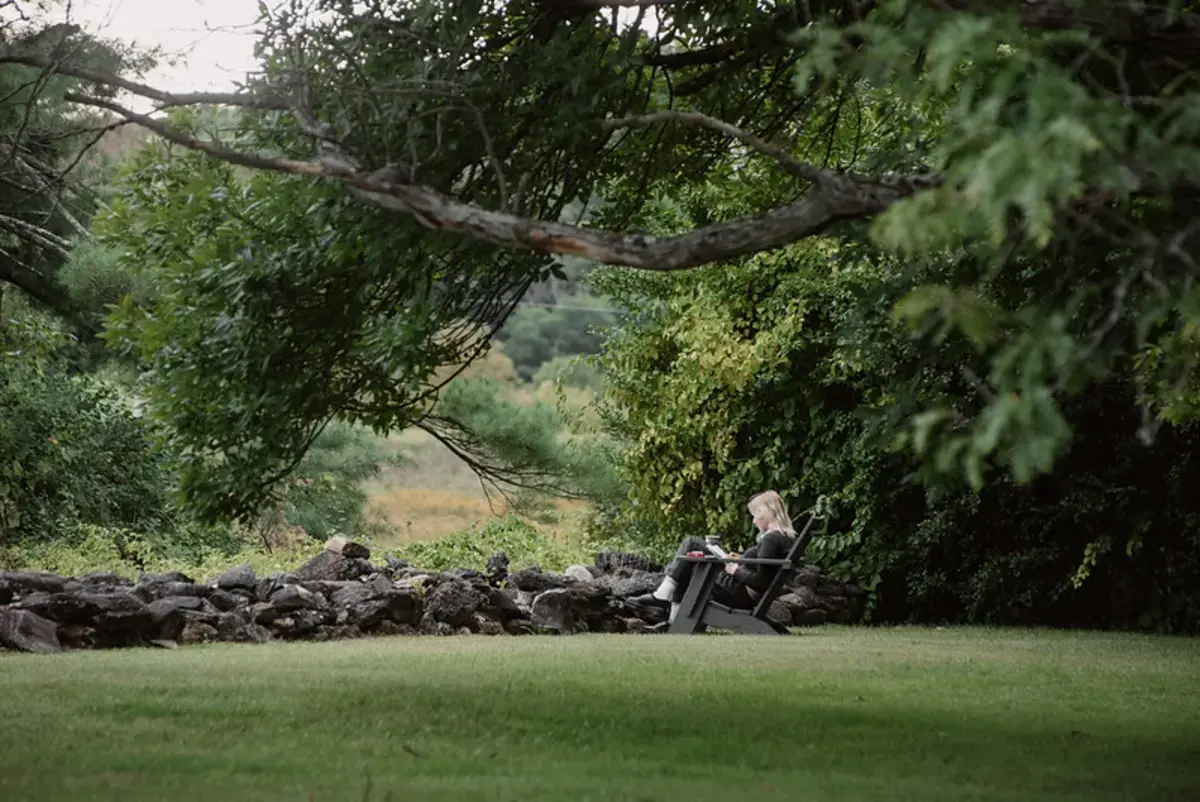Image of student reading outside