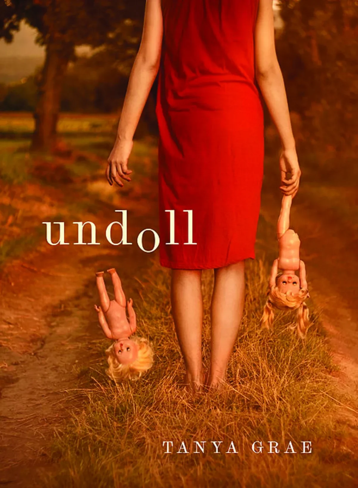 hazy orange book cover of a woman in a red dress walking away holding a doll in each hand