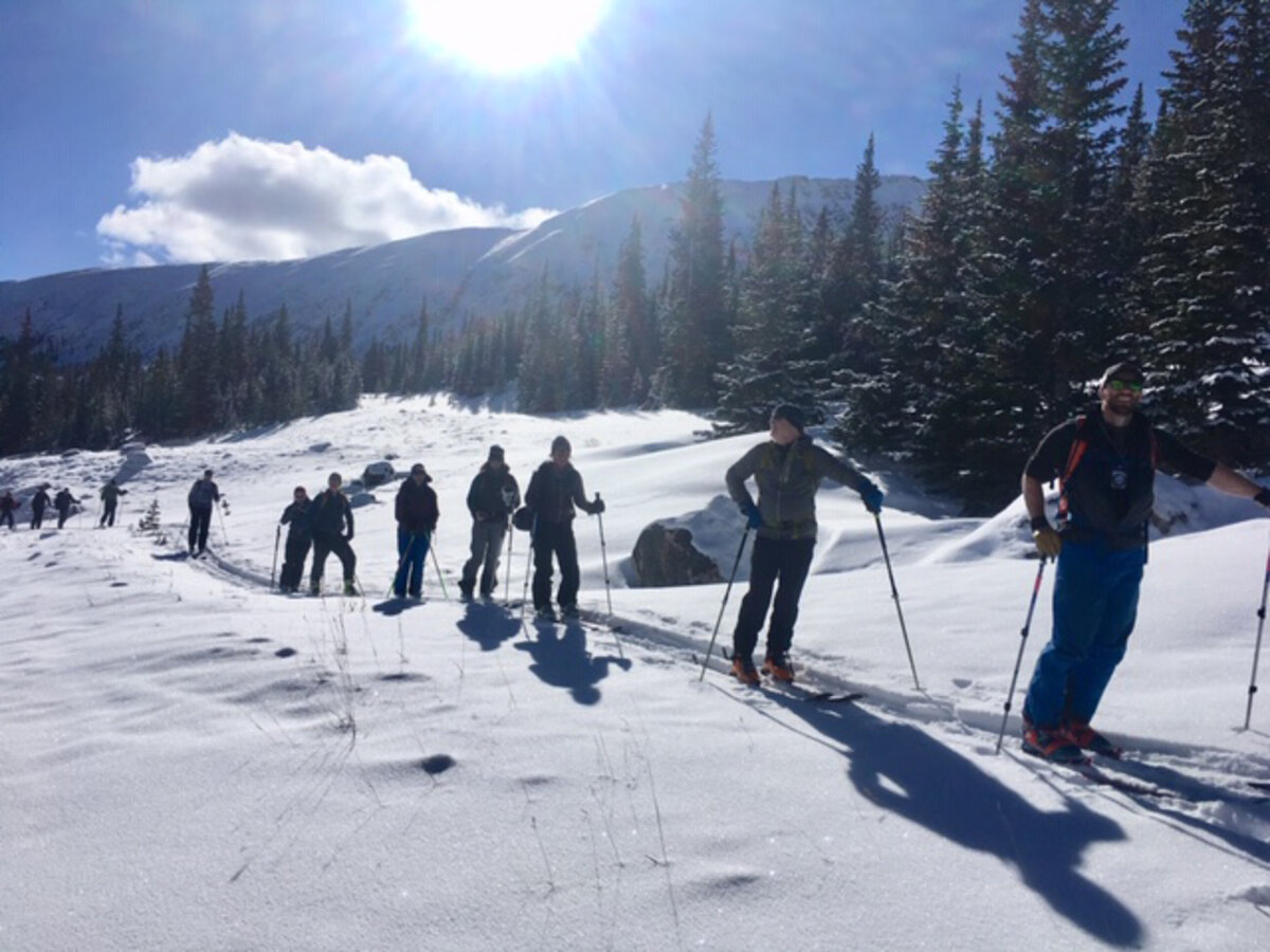 Backcountry skiers make their way up a hill