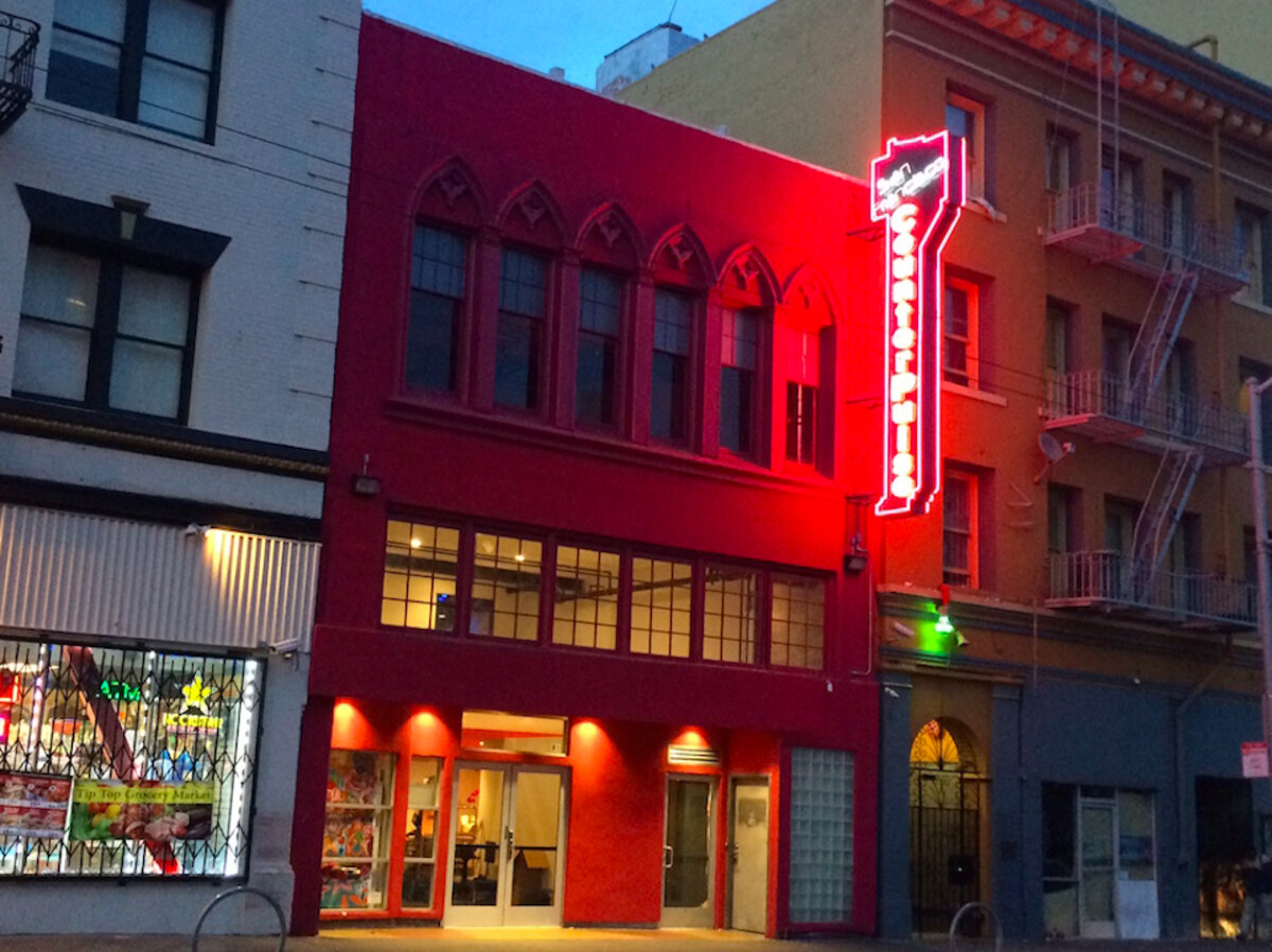 building with a red neon light sign