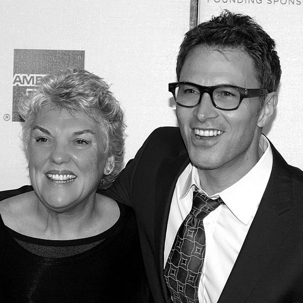 Actors Tim Daly and Tyne Daly posing for the camera in black and white