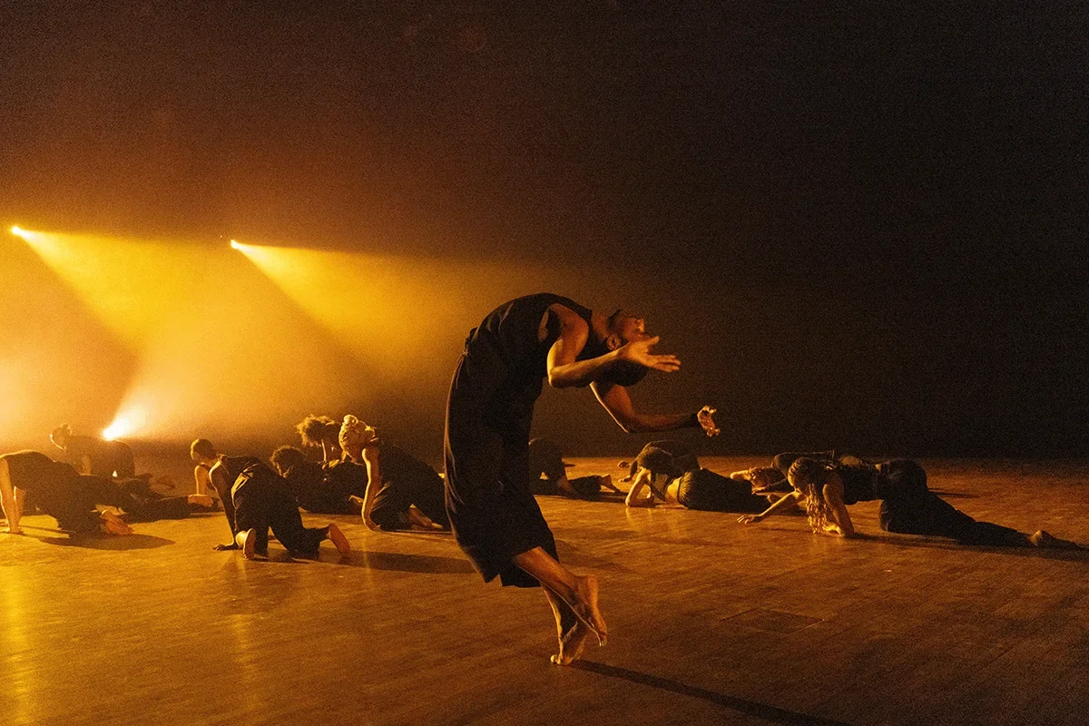a BFA Dance Lab student arches his back during a performance