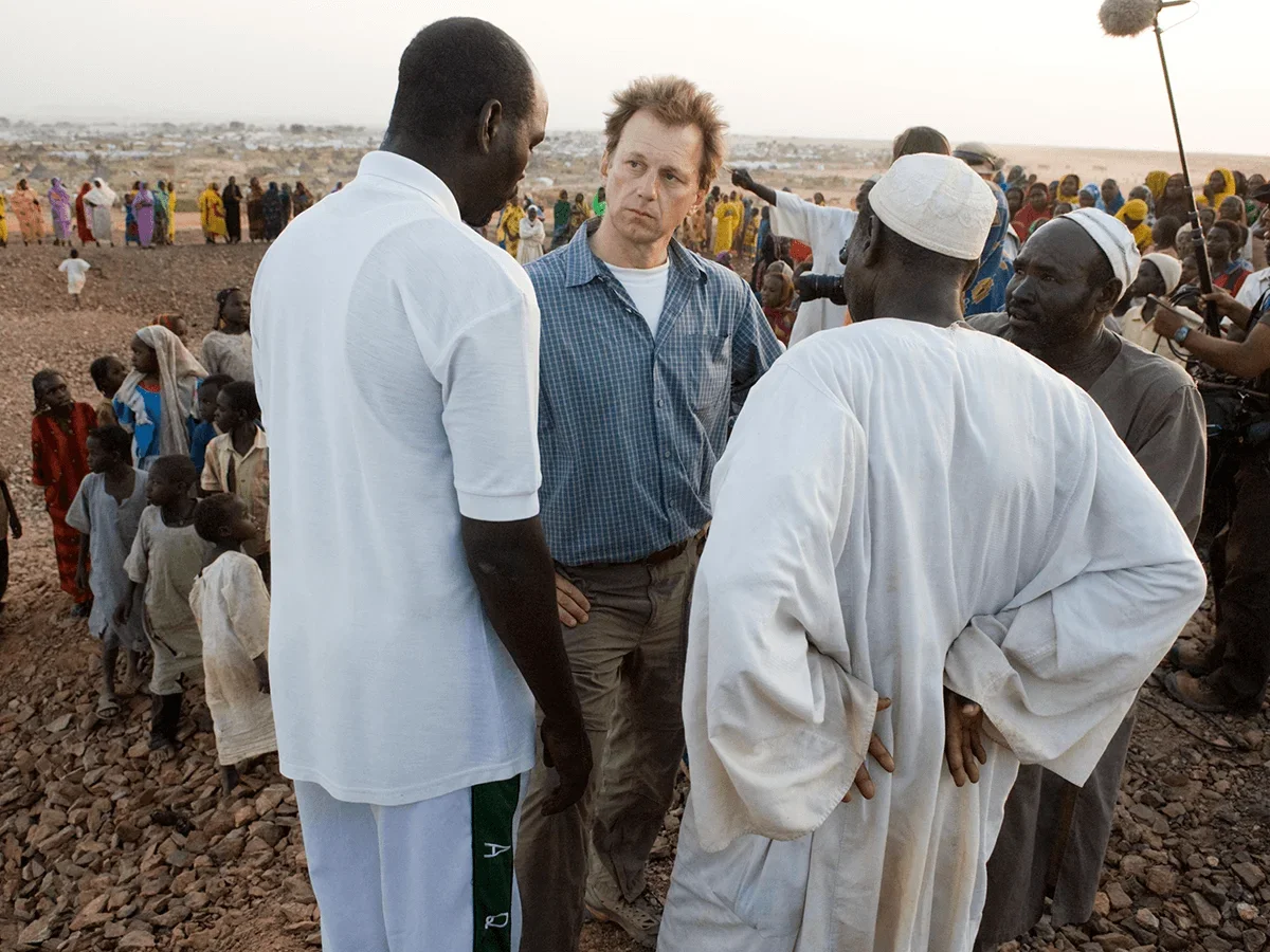 Ted Braun speaking with cast on set