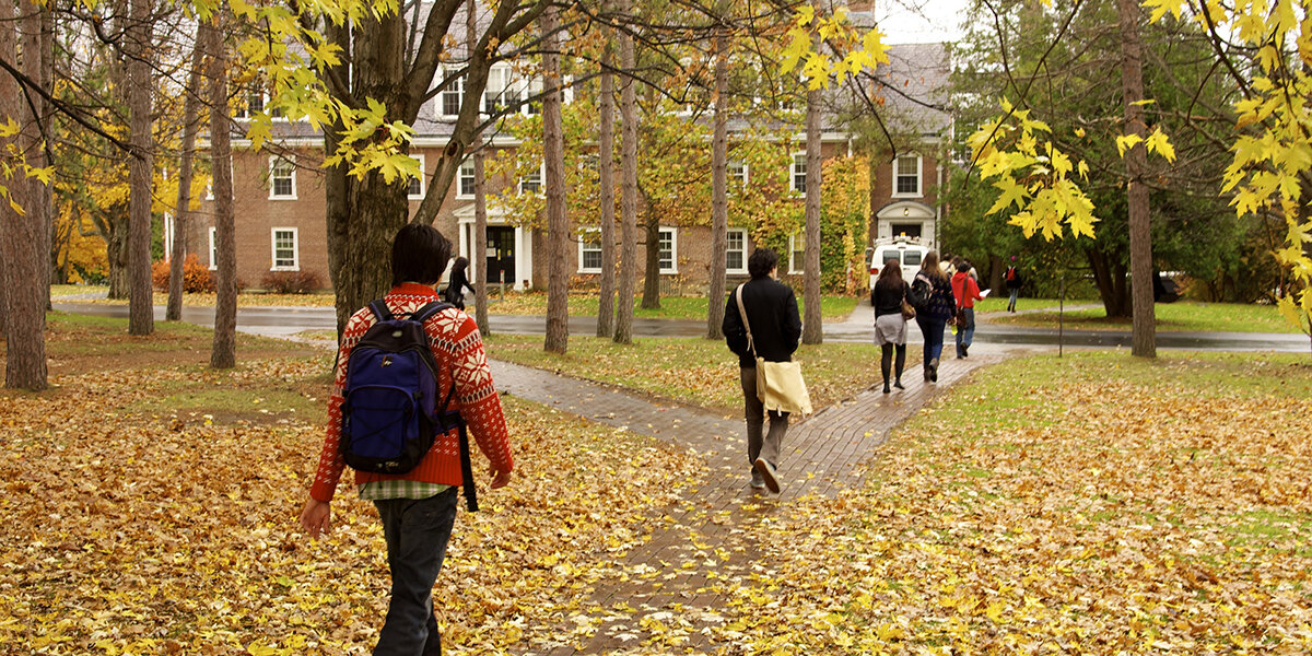 students walking on fallen leaves