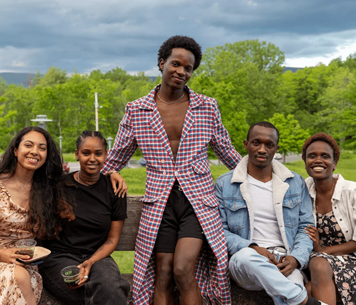 a student poses with their family and friends