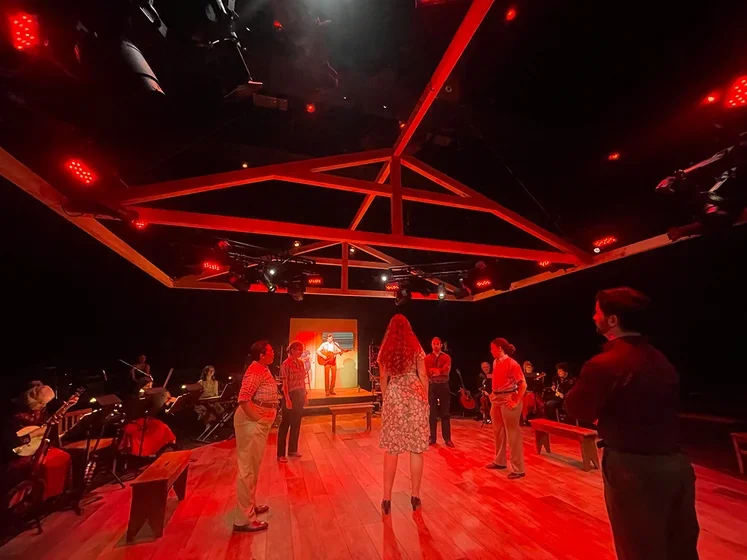 Actors on red colored stage