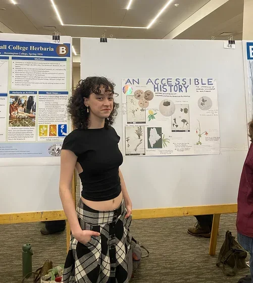 Image of student in front of poster