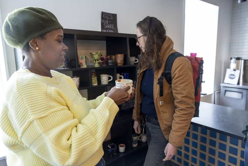 Anina Major (left) and faculty member in CAPA Kelie Bowman admire mugs.