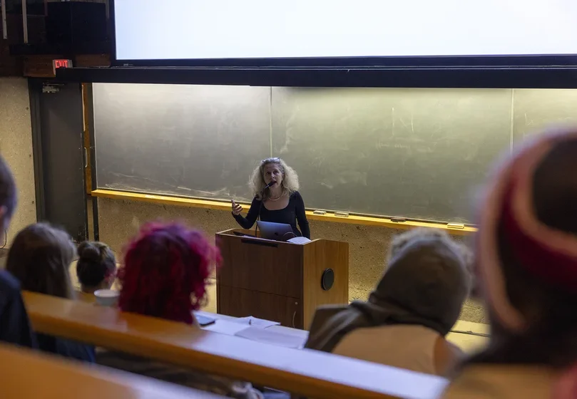 faculty member in Cultural Studies and Languages (CSL) Noelle Rouxel-Cubberly addresses the class gathered in Tishman Lecture Hall