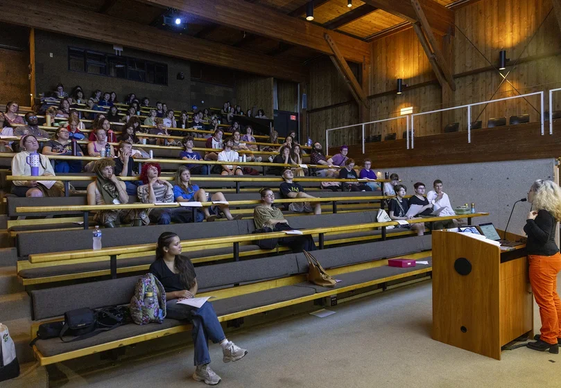 faculty member in Cultural Studies and Languages (CSL) Noelle Rouxel-Cubberly addresses the class gathered in Tishman Lecture Hall