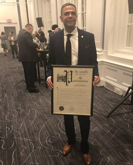 Image of man in suit holding proclamation