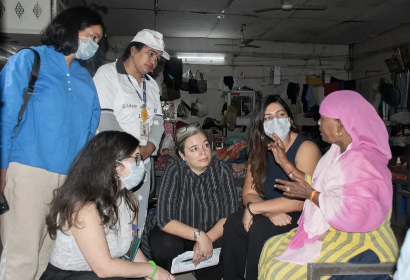 Kachina (center) visiting a USAID funded program in New Delhi that helped people access tuberculosis treatment in a homeless shelter.