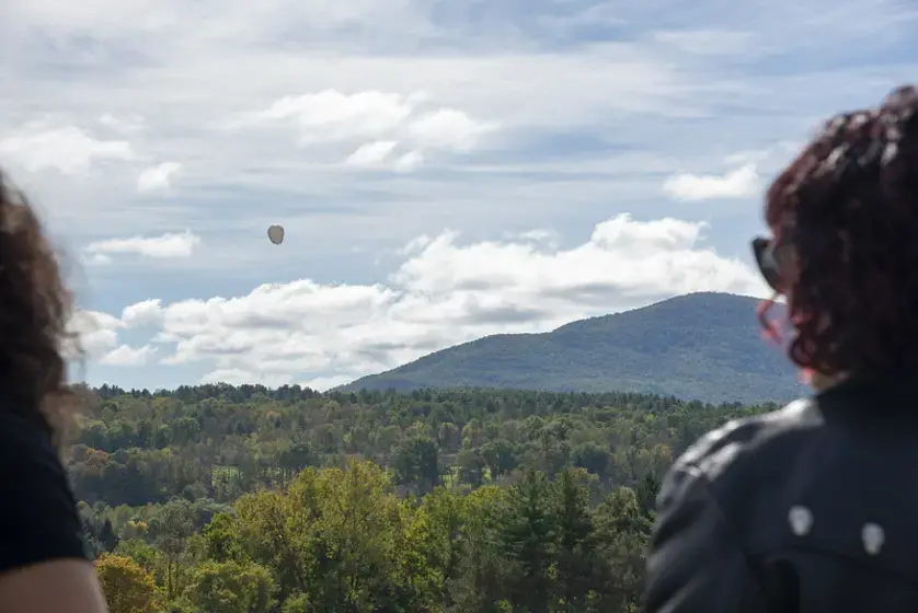 Image of two people overlooking mountains