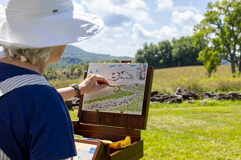 Image of woman painting landscape