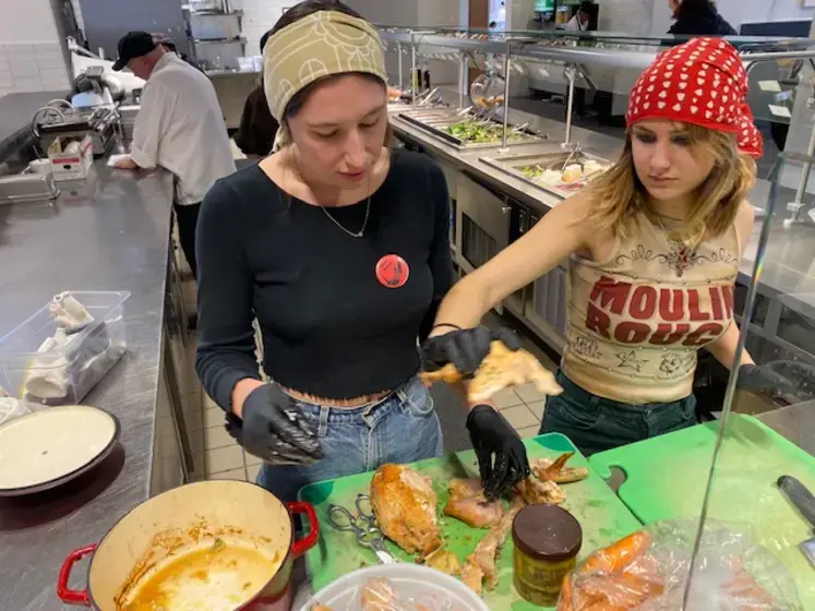 Photo of two students cooking