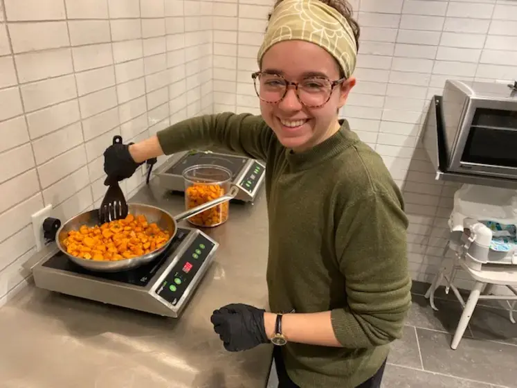 Photo of student and soup bowl